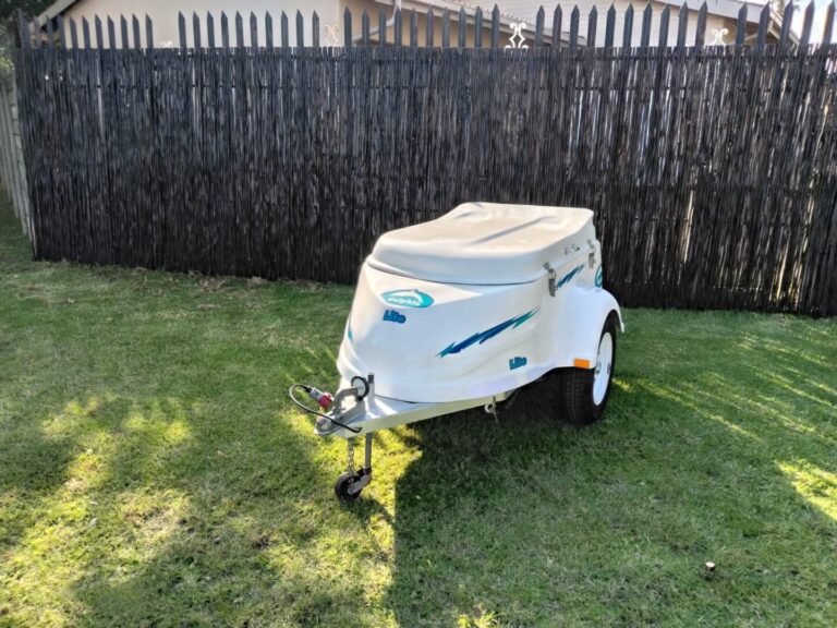 Front side view of white Dolphin Lite trailer
