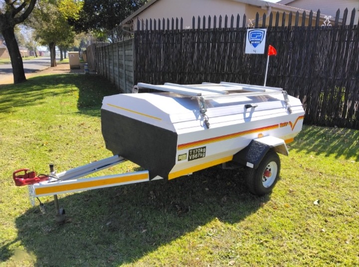 Side view of refurbished Venter luggage trailer on grass