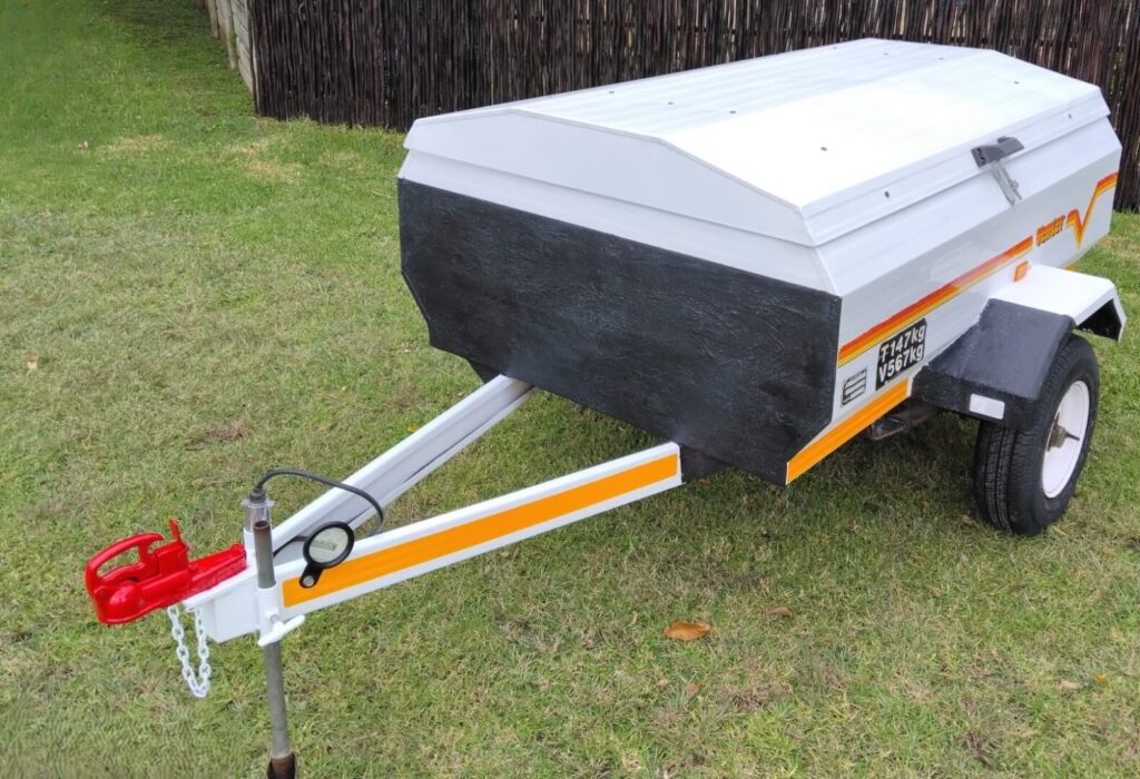 Front side view of white Venter trailer with black nose panel