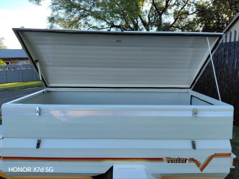 Open side view of Venter trailer lid and storage area